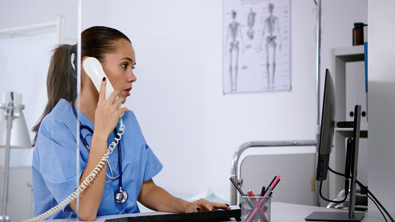 specialist healthcare physician talking phone medicine clinic receptionist doctor assistant helping with telehealth concultation nurse working hospital checking registration computer 1